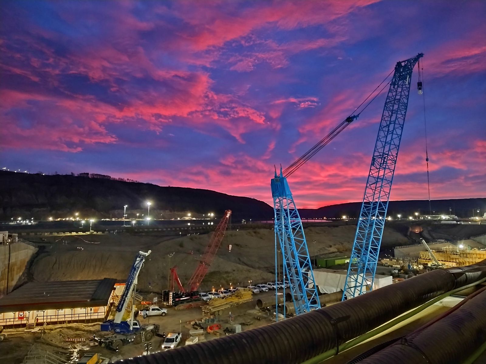 Cranes on the Site C project at sunrise